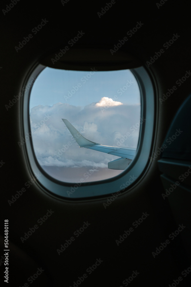 Clouds behind aircraft window Clouds behind aircraft window