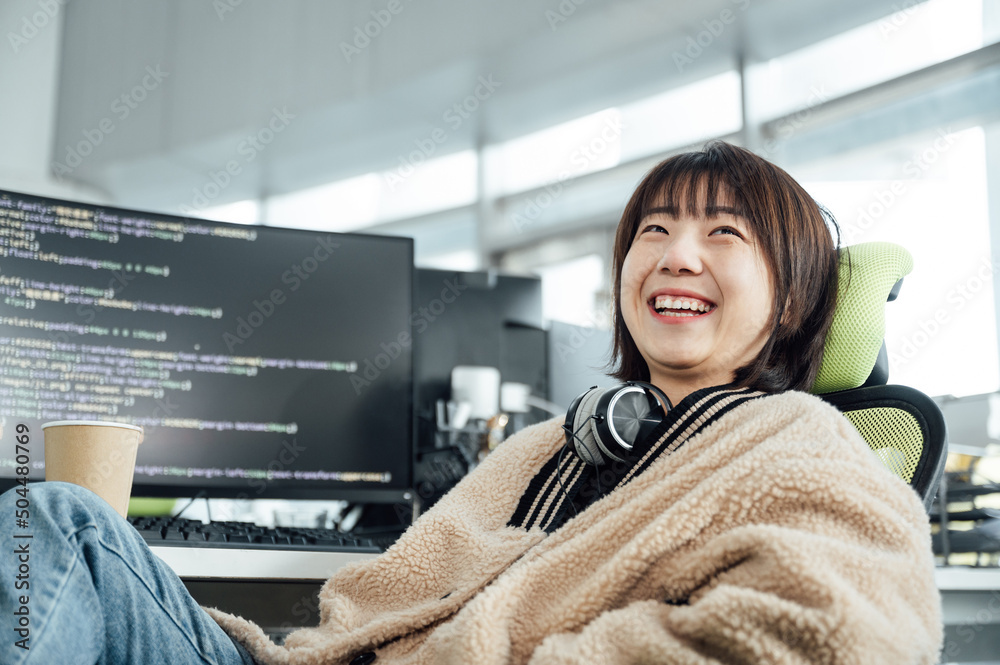 © ZQZ Studio/Stocksy - Young business woman smiling in office © ZQZ Studio/Stocksy - Young business woman smiling in office