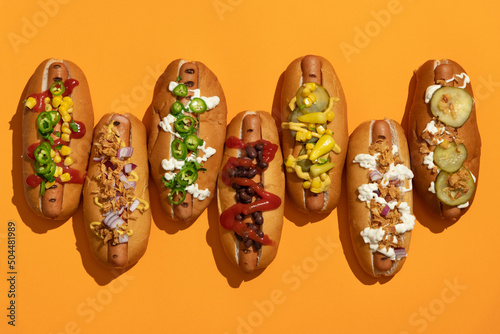 Finger food: grilled hot dogs with condiments and toppings photo