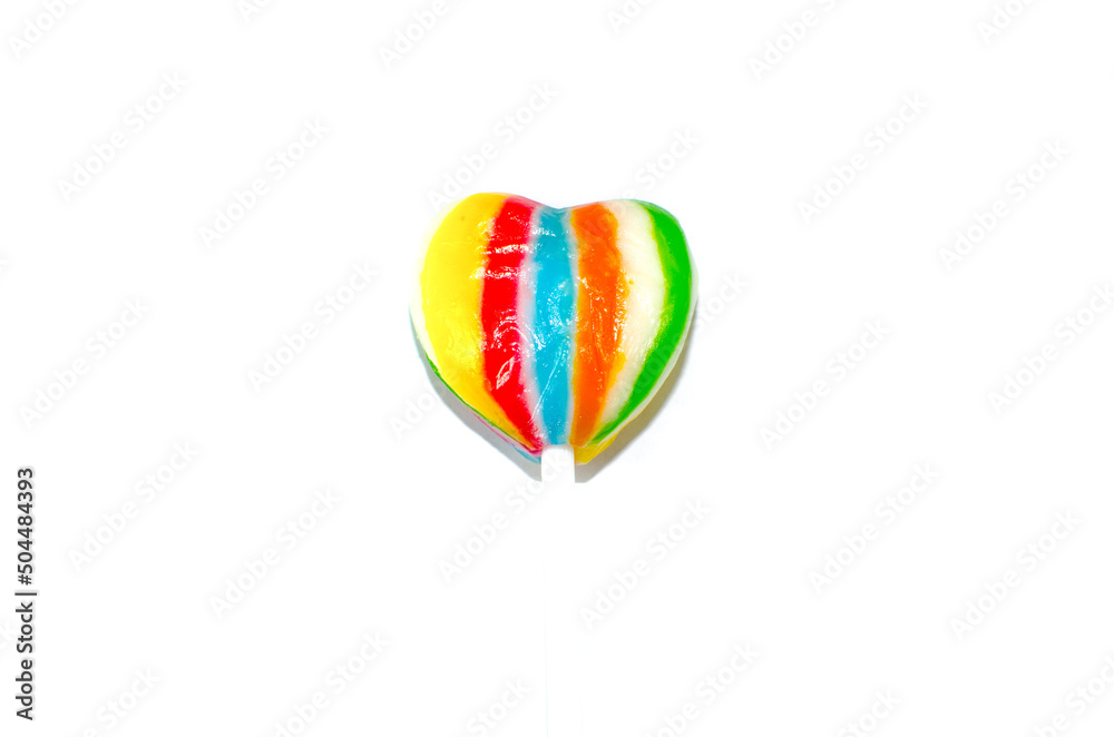 Single heart shaped lollipop in rainbow color isolated on white background. Single heart shaped lollipop in rainbow color isolated on white background.