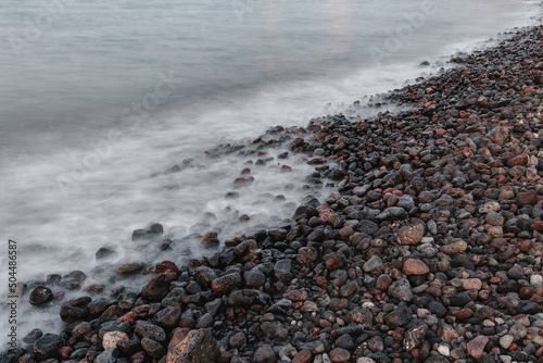 The white waves on the gravel beach. photo