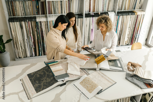 Women Looking At White Fabric In A Store photo