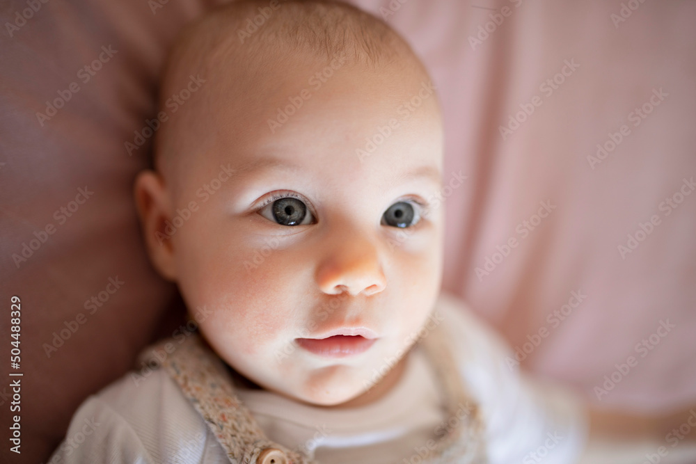 Cute baby lying on bed looking at camera Cute baby lying on bed looking at camera
