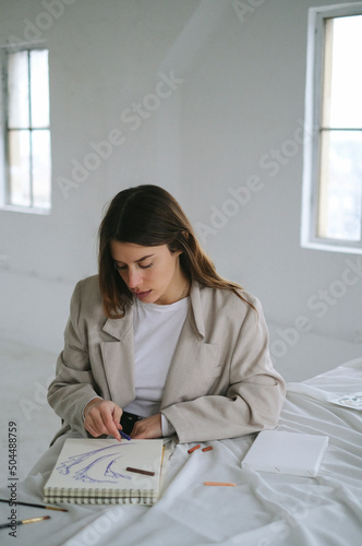 Portrait of Artist Drawing In Her Sketchbook  photo
