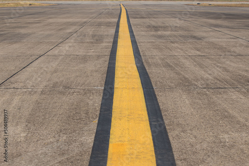 Yellow line painting on taxiway to guide pilot of airplane to drive at the airport © Gan