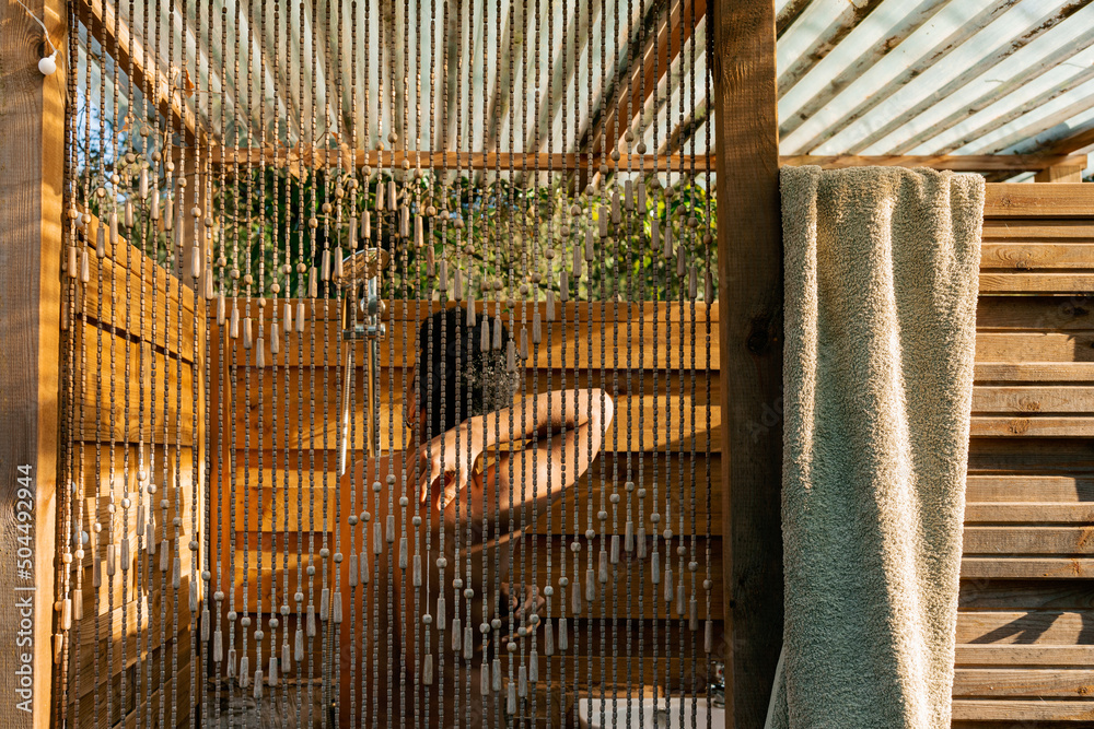 Man Rinsing Off In Outdoor Shower
