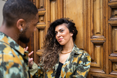 Mixed-Race Couple With Camouflage Fabric Clothes Looking At Each Other photo