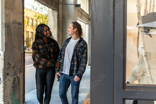 Happy Couple Walk in Outdoor Shopping Plaza photo