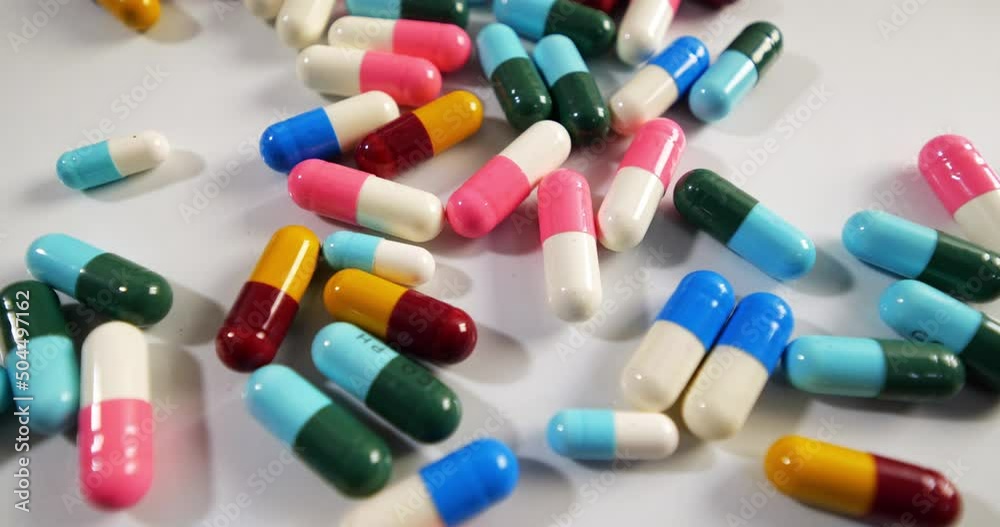 Pills drugs capsules falling on white background
Pills drugs capsules falling on white background
