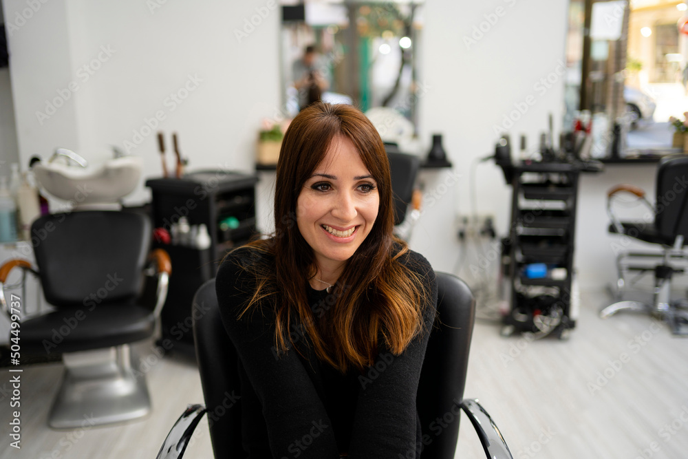 Smiling female sitting in salon Smiling female sitting in salon