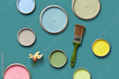 Paint brush, spring flower and colorful lids from tin cans photo