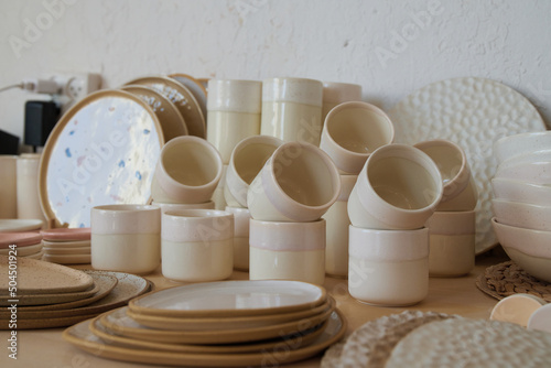 Handmade glasses and plates in a ceramic studio photo