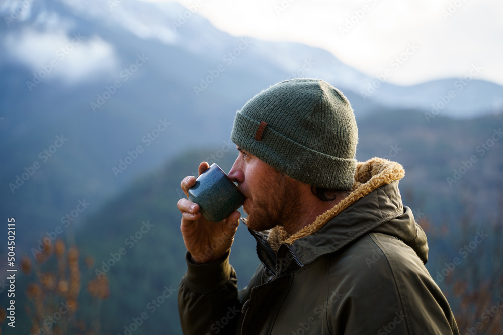 Portrait of happy man drinking coffee cup in the mountain Portrait of happy man drinking coffee cup in the mountain