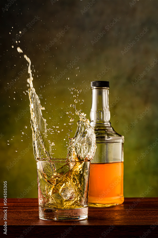 Whiskey splashing out of glass