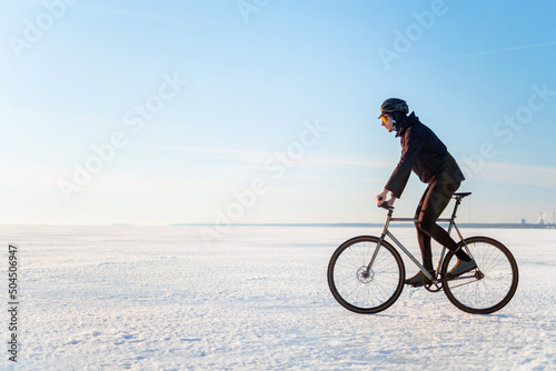 The rider on a bicycle rides on ice