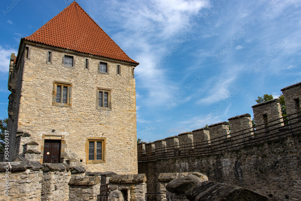 A stone tower in the castle courtyard with battlements