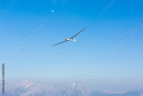 glider flies in the sky photo