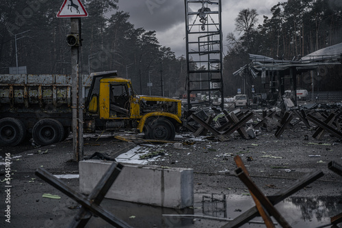 Anti tank hedgehogs and burned cars on road photo