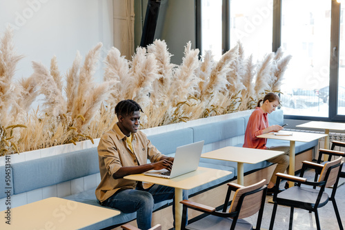 Multiracial colleagues working in common space