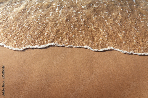 Fototapeta beautiful sandy beach and  water ocean wave on sand