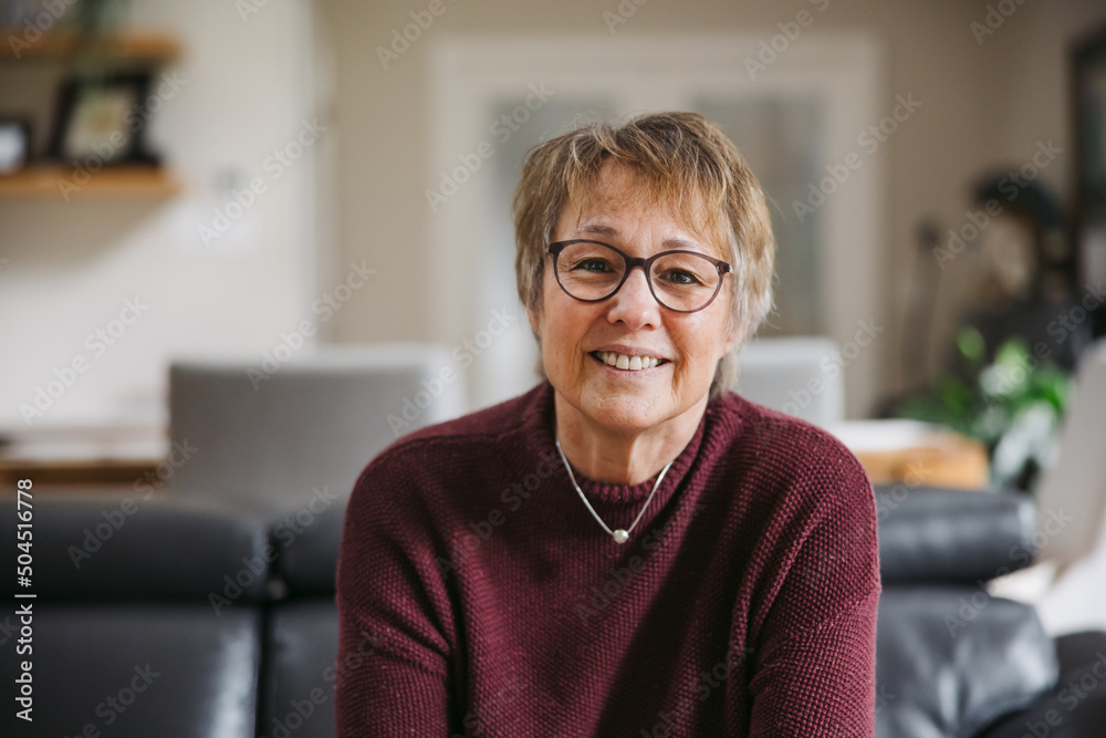 Woman on couch smiling at camera. Woman on couch smiling at camera.