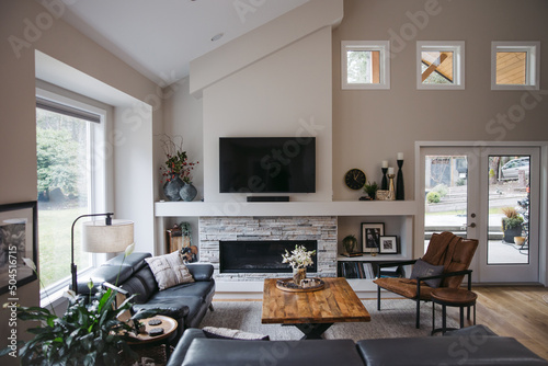Empty living room with vaulted ceiling.