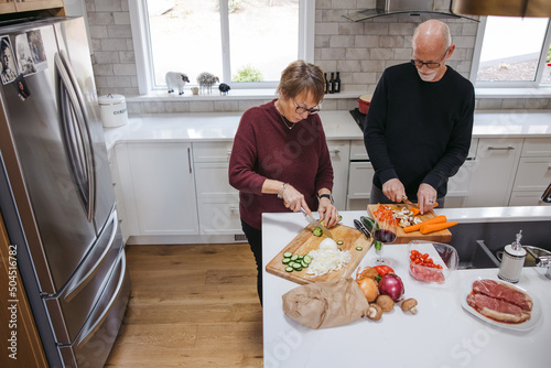 Mature couple making meal together. photo