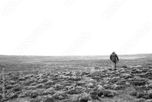 unrecognizable man walking in patagonia's fields