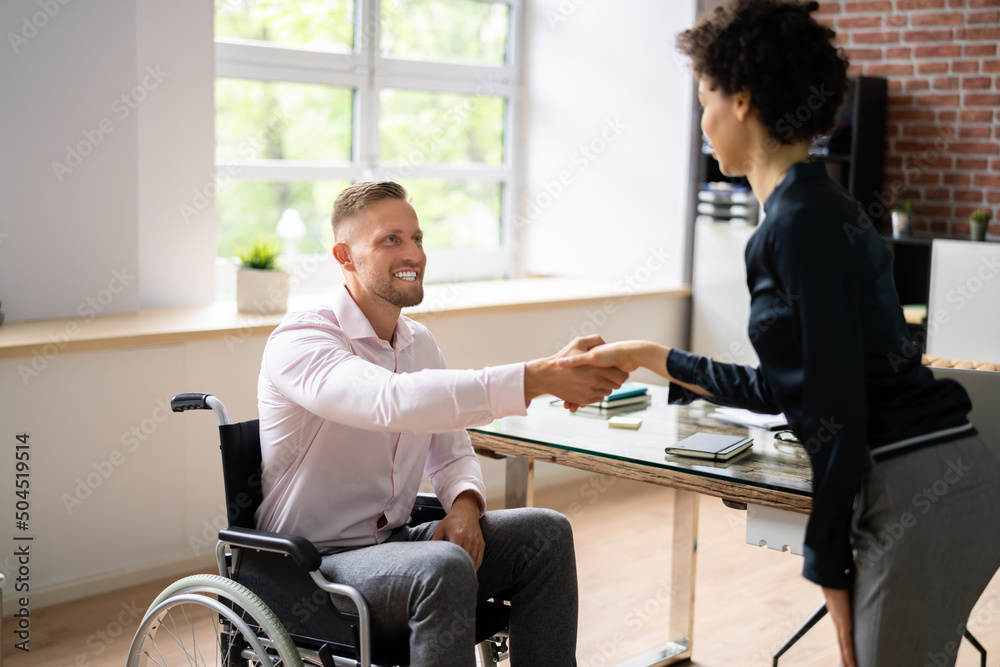 Businessman Shaking Hands With Disabled Businesswoman Businessman Shaking Hands With Disabled Businesswoman
