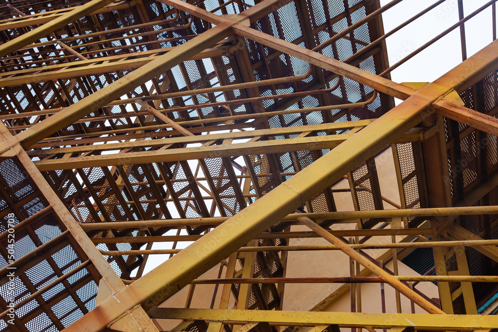 Steel welded structure with iron ladder inside. Stair tower close-up.