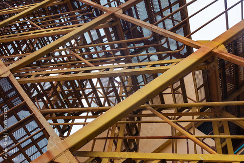 Steel welded structure with iron ladder inside. Stair tower close-up.