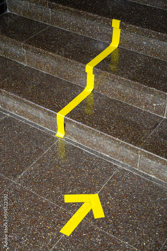 Yellow duct tape on the floor. photo