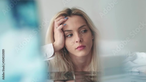 Sad woman. Stress frustration. Lonely sorrow. Creative portrait of depressed anxious tired emotion female in blurred mirror glass light background. photo