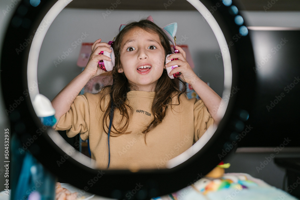 Preteen blogger in headphones recording video Stock Photo | Adobe Stock