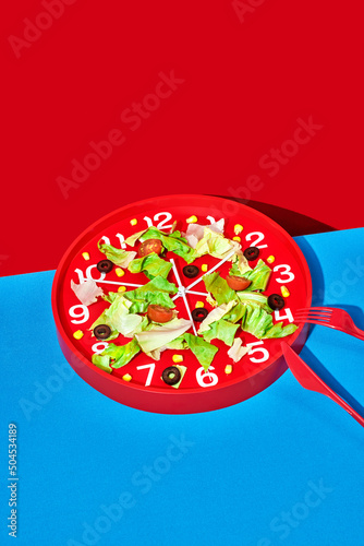 some salad served on a red clock photo