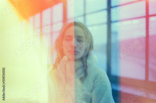 Portrait of a blond girl with big windows and rainbow colours 