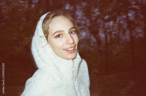 Blond woman walk in white hoodie smile and look to the camera photo