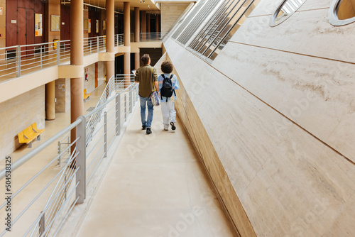 Students walking through university corridors photo