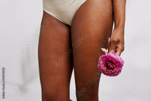 Woman in panties with pink flower photo