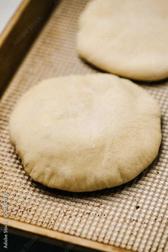 Pita bread on a baking sheet Pita bread on a baking sheet