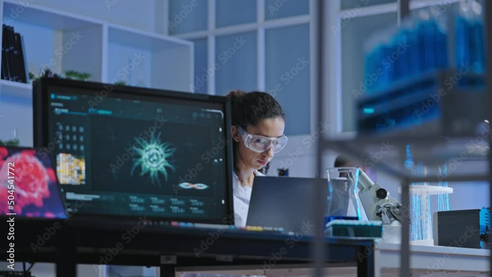 Bacteriology lab scientist working on research, using modern computer technology