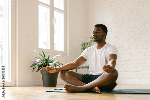 Male meditating indoors photo