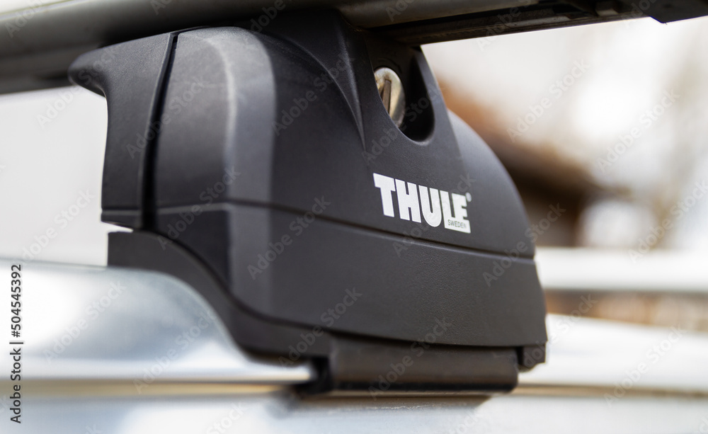 Thule roof rack system bars mounted on top of a car rooftop on