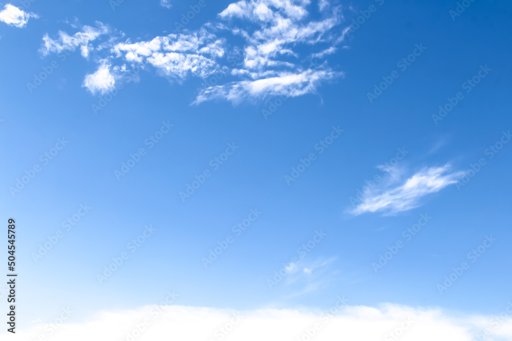 Colorful bright blue sky background with white clouds patterns and vast space