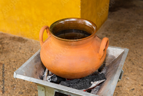 Clay pot on an anafre or wood stove  photo