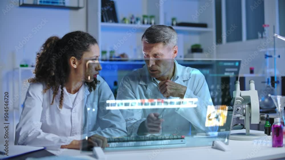 Genetics lab workers upset with human genome experiment results, looking screen Genetics lab workers upset with human genome experiment results, looking screen