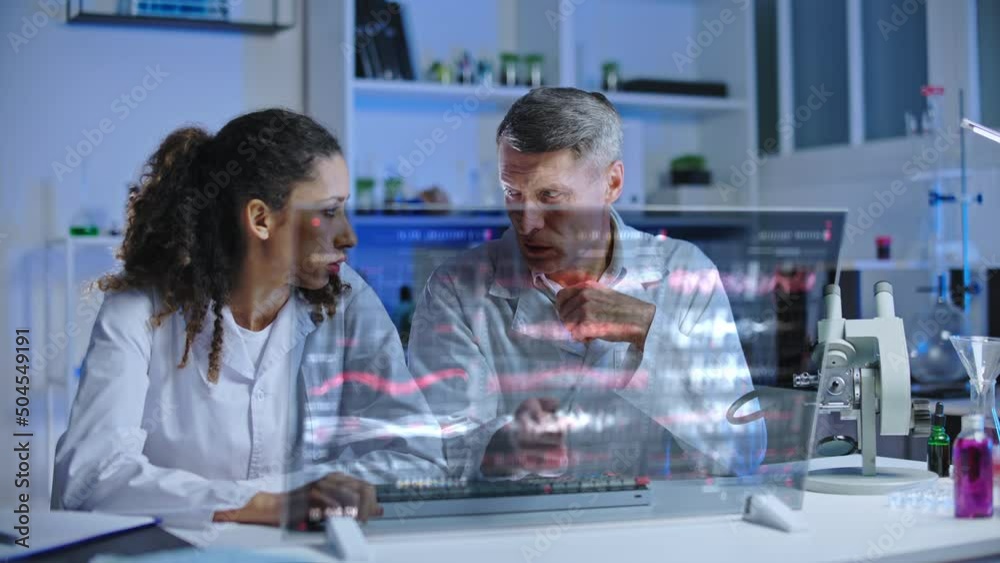 Distressed scientists looking at experiment results on computer screen, failure Distressed scientists looking at experiment results on computer screen, failure