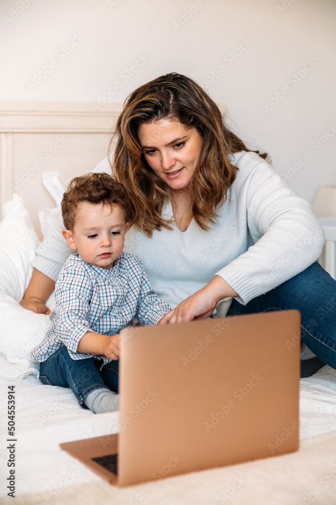 mother and son watching cartoon with child on laptop mother and son watching cartoon with child on laptop