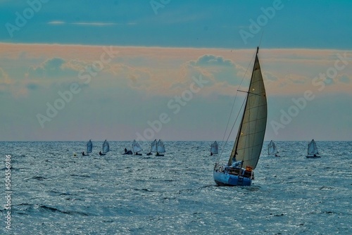 Sailing boats sailing near the coast of El Campello in Alicante, Spain photo