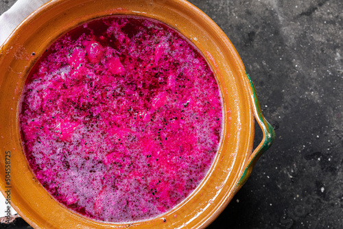 red prickly pear fermentation inside a clay pot  photo
